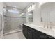 Bright bathroom featuring double vanity, modern sinks, and glass-enclosed shower with bench at 310 N Dotger N Ave # 4, Charlotte, NC 28204