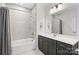 Clean bathroom with tub and shower combination, updated vanity, and sleek hardware at 310 N Dotger N Ave # 4, Charlotte, NC 28204