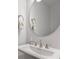Modern bathroom sink with round mirror and decorative hand soap dispenser at 310 N Dotger N Ave # 4, Charlotte, NC 28204