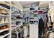 Spacious walk-in closet with ample shelving, hanging storage and built-in drawers at 310 N Dotger N Ave # 4, Charlotte, NC 28204