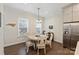 Sunlit dining area featuring a round table, seating for six, and dark hardwood floors at 310 N Dotger N Ave # 4, Charlotte, NC 28204