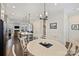 Open floor plan with a dining area featuring a round table and views into the living area and kitchen at 310 N Dotger N Ave # 4, Charlotte, NC 28204