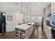 Well-designed kitchen with central island, stainless appliances, and adjacent dining area at 310 N Dotger N Ave # 4, Charlotte, NC 28204