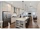 Bright kitchen with stainless steel appliances, oversized island, pendant lighting, and hardwood flooring at 310 N Dotger N Ave # 4, Charlotte, NC 28204
