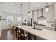 Beautiful kitchen with stainless steel appliances and island with barstool seating leading to dining room at 310 N Dotger N Ave # 4, Charlotte, NC 28204