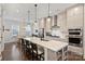 Bright kitchen showcasing stainless steel appliances, spacious island, and open layout to the breakfast nook at 310 N Dotger N Ave # 4, Charlotte, NC 28204