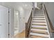 Well-lit stairway with hardwood steps, leading to a bathroom with a glass-enclosed shower at 310 N Dotger N Ave # 4, Charlotte, NC 28204