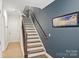 Bright stairway featuring hardwood steps, navy blue wall and a window view at 310 N Dotger N Ave # 4, Charlotte, NC 28204