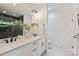 Modern bathroom featuring a double vanity with white cabinets and a glass shower with black subway tile at 3163 Maury St, Charlotte, NC 28208
