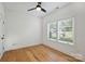 Bright bedroom with hardwood floors, a modern ceiling fan, and two windows offering ample natural light at 3163 Maury St, Charlotte, NC 28208