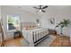 Bright bedroom with a comfortable bed, stylish decor, hardwood floors, and large windows that allow natural light at 3163 Maury St, Charlotte, NC 28208