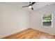 Bright bedroom with hardwood floors, a modern ceiling fan, and a large window offering natural light at 3163 Maury St, Charlotte, NC 28208