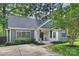 Charming home displaying gray siding, white brick accents, mature trees, and a well-maintained front lawn at 3163 Maury St, Charlotte, NC 28208