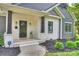Inviting front porch with white brick columns, dark accents, and manicured landscaping around the home at 3163 Maury St, Charlotte, NC 28208