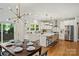 Modern kitchen features white cabinetry, a large island with seating, stainless steel appliances, and stylish pendant lighting at 3163 Maury St, Charlotte, NC 28208