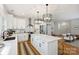 Modern kitchen featuring a large island with bar seating, stainless steel appliances, and hardwood floors at 3163 Maury St, Charlotte, NC 28208