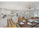 Open-concept kitchen and dining area with a large island, modern appliances, hardwood floors, and stylish lighting at 3163 Maury St, Charlotte, NC 28208