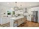 Bright, modern kitchen with white cabinetry, a center island, stainless steel appliances, and hardwood floors at 3163 Maury St, Charlotte, NC 28208