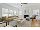 Elegant living room showcasing an eye-catching fireplace, plentiful natural light, and a seamless flow for gatherings at 3163 Maury St, Charlotte, NC 28208