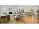Open-concept living area features a marble fireplace, modern furnishings, and seamless access to the dining area at 3163 Maury St, Charlotte, NC 28208