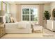 A modern minimalist bedroom features a large window, natural light, and calming neutral tones at 3882 Horsham St, Indian Land, SC 29707