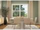 Elegant dining area featuring woven chairs, a white table, and a large window at 3882 Horsham St, Indian Land, SC 29707