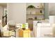 Inviting living room with comfortable seating, bright sunlight, neutral tones, and decor on floating shelves at 3882 Horsham St, Indian Land, SC 29707