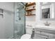 Bathroom featuring a tiled shower, glass door, and modern vanity with shelving at 3900 Langley Rd, Charlotte, NC 28215
