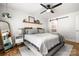 This bedroom features a large bed, ceiling fan, sliding door and decorative shelving at 3900 Langley Rd, Charlotte, NC 28215