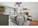 This bright bedroom features a large window, ceiling fan, and a decorative shelf at 3900 Langley Rd, Charlotte, NC 28215