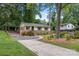 Quaint home with a long driveway, established trees, and a traditional exterior design at 3900 Langley Rd, Charlotte, NC 28215