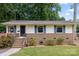 Attractive single-story home boasting blue shutters, a brick facade, and manicured landscaping at 3900 Langley Rd, Charlotte, NC 28215