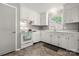 Bright kitchen with white cabinets, modern appliances, and ample counter space at 3900 Langley Rd, Charlotte, NC 28215