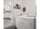 This laundry area features a washer, dryer, and shelving for storage at 3900 Langley Rd, Charlotte, NC 28215