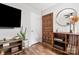 Inviting living room featuring hardwood floors, a decorative front door, and modern decor at 3900 Langley Rd, Charlotte, NC 28215