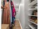 This walk-in closet has hanging storage and shelving for shoes and accessories at 3900 Langley Rd, Charlotte, NC 28215