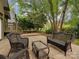 Seating area and brick patio with bench in shady backyard at 4025 Woodfox Dr, Charlotte, NC 28277