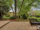 Brick patio with seating in lush backyard at 4025 Woodfox Dr, Charlotte, NC 28277