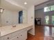 Bathroom featuring a large mirror, double sinks, and a view of the living area at 4025 Woodfox Dr, Charlotte, NC 28277