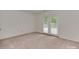 Bright bedroom with carpet flooring and natural light streaming in from large double doors at 4025 Woodfox Dr, Charlotte, NC 28277