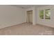 Well-lit bedroom with carpet, closet, and a window with natural light at 4025 Woodfox Dr, Charlotte, NC 28277