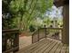 Wooden deck with stairs overlooks the beautiful and shady backyard with a brick paver patio at 4025 Woodfox Dr, Charlotte, NC 28277