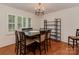 Formal dining room with hardwood floors, shuttered windows, and a modern chandelier at 4025 Woodfox Dr, Charlotte, NC 28277