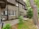 The exterior side of the house features neutral vertical siding and a small brick paver patio at 4025 Woodfox Dr, Charlotte, NC 28277