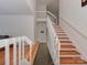 Bright foyer featuring hardwood stairs, a stone tile floor, and white railings at 4025 Woodfox Dr, Charlotte, NC 28277