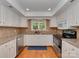 Bright kitchen with white cabinets, granite countertops, and stainless steel appliances at 4025 Woodfox Dr, Charlotte, NC 28277