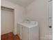 Functional laundry room with washer, dryer, and laminate wood flooring at 4025 Woodfox Dr, Charlotte, NC 28277