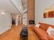 Cozy living room with hardwood floors, a brick fireplace, and a leather sofa at 4025 Woodfox Dr, Charlotte, NC 28277