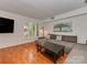 Bright living room with hardwood floors, large windows, and comfortable seating at 4025 Woodfox Dr, Charlotte, NC 28277