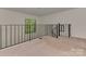 Cozy loft space featuring carpet, iron railing, and a bright window at 4025 Woodfox Dr, Charlotte, NC 28277